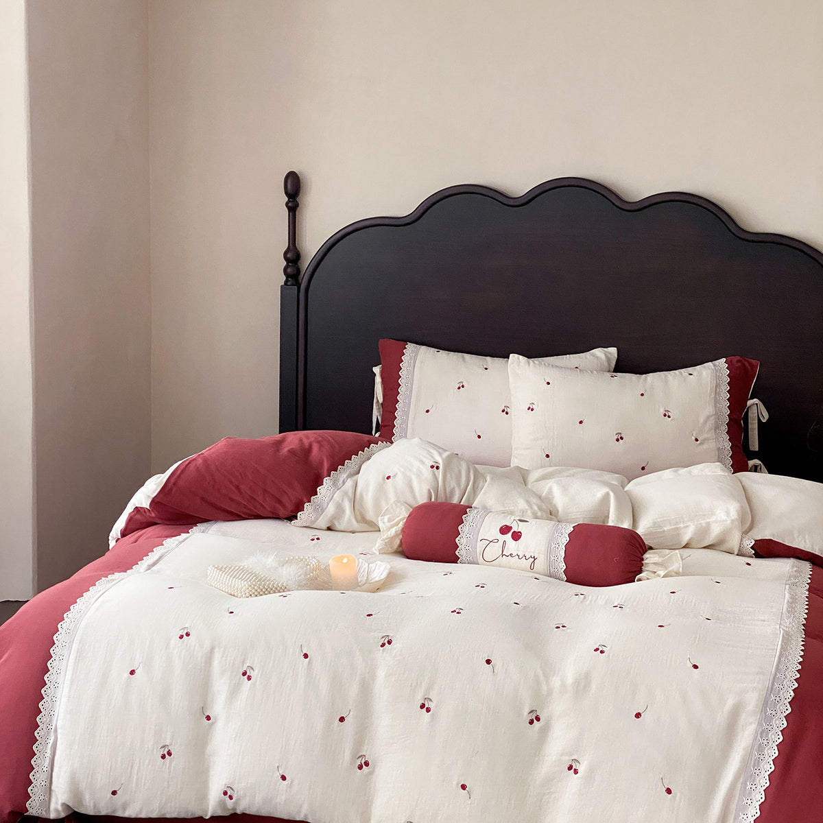 Country-style bedding set with cherry embroidery, lace trim, and decorative neck roll