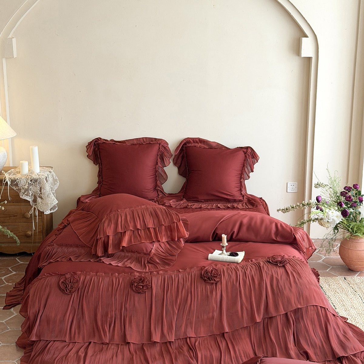 Romantic satin bedding set with layered ruffles and rose appliqués