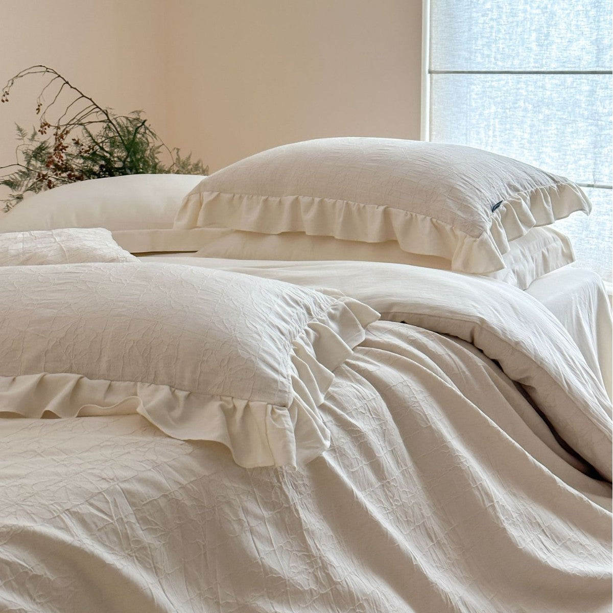 Quilted cotton-linen duvet cover set with subtle wrinkled texture and ruffle