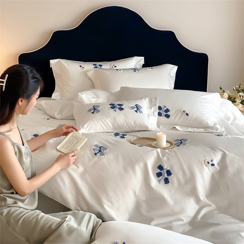 Embroidered cotton satin bedding set with subtle blue flower patterns