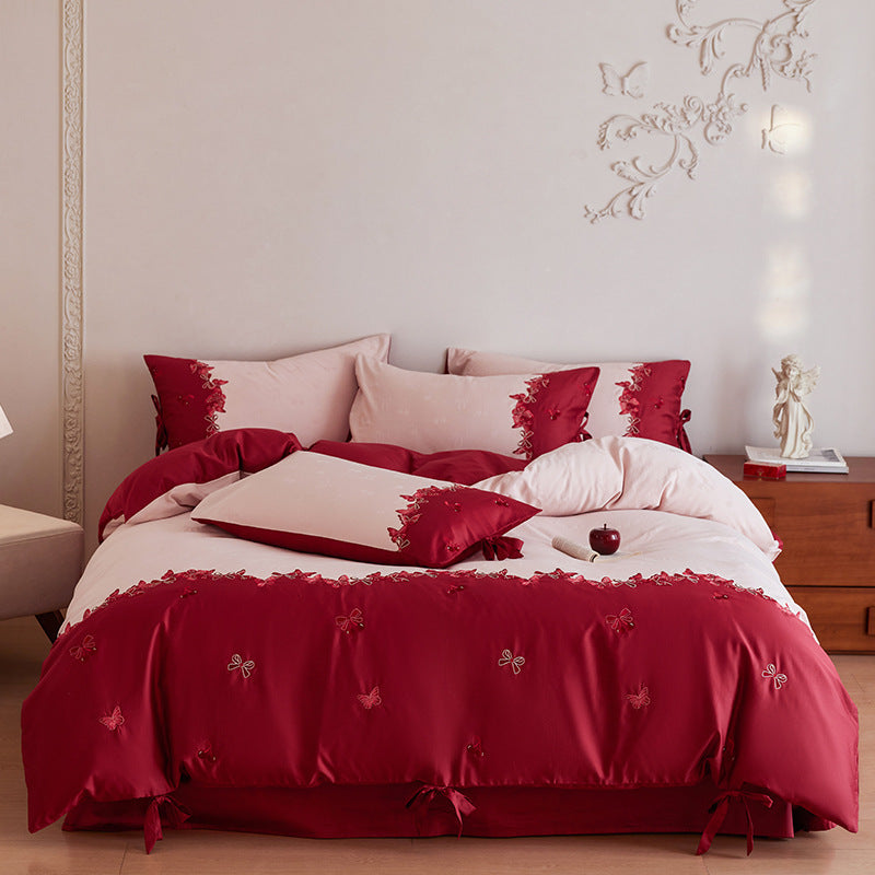 Cotton satin bedding set with butterfly embroidery, decorative bows, and reversible cover