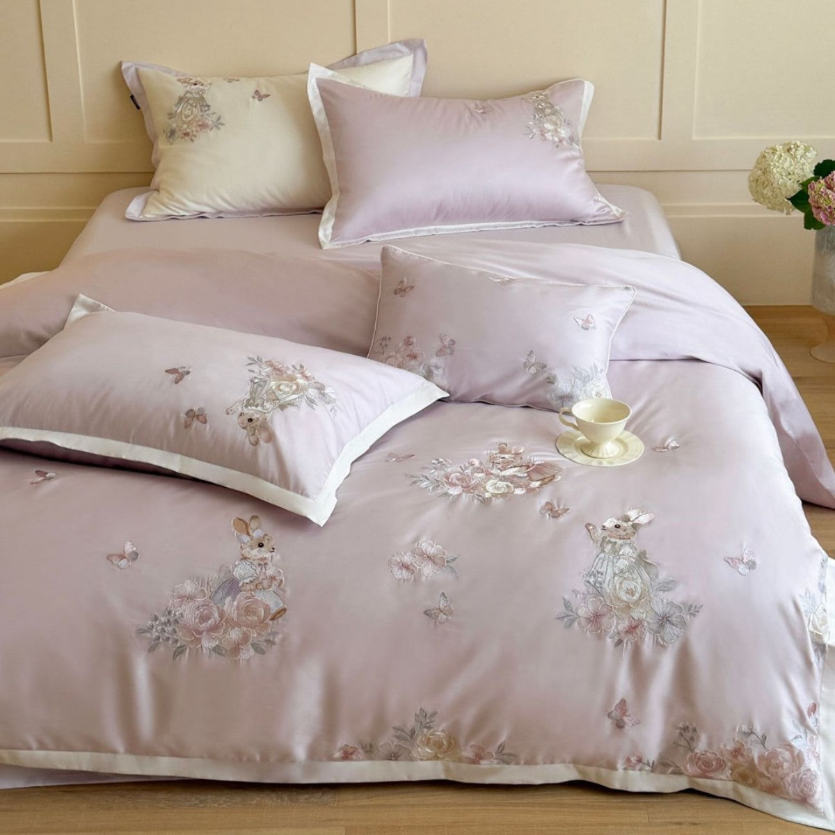 Finely embroidered bedding set with floral motifs and animal appliqués