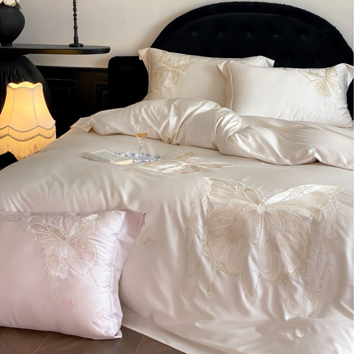 Luxurious satin bedding set with embroidered butterfly motifs and silky glossy finish