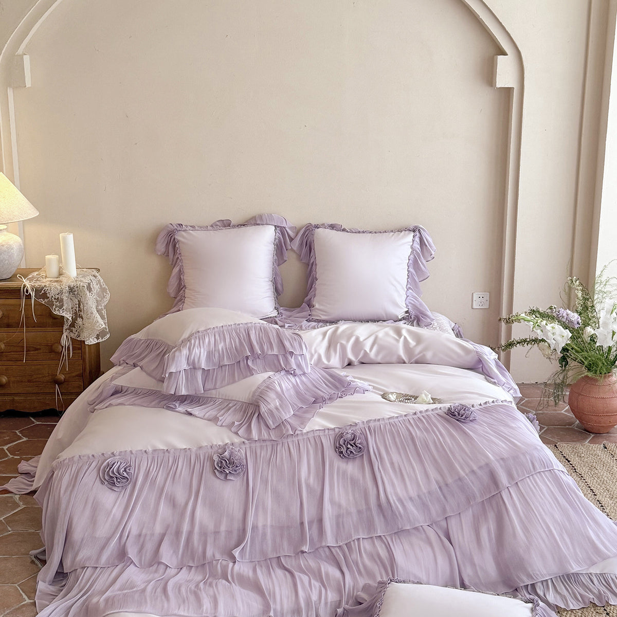 Romantic satin bedding set with layered ruffles and rose appliqués