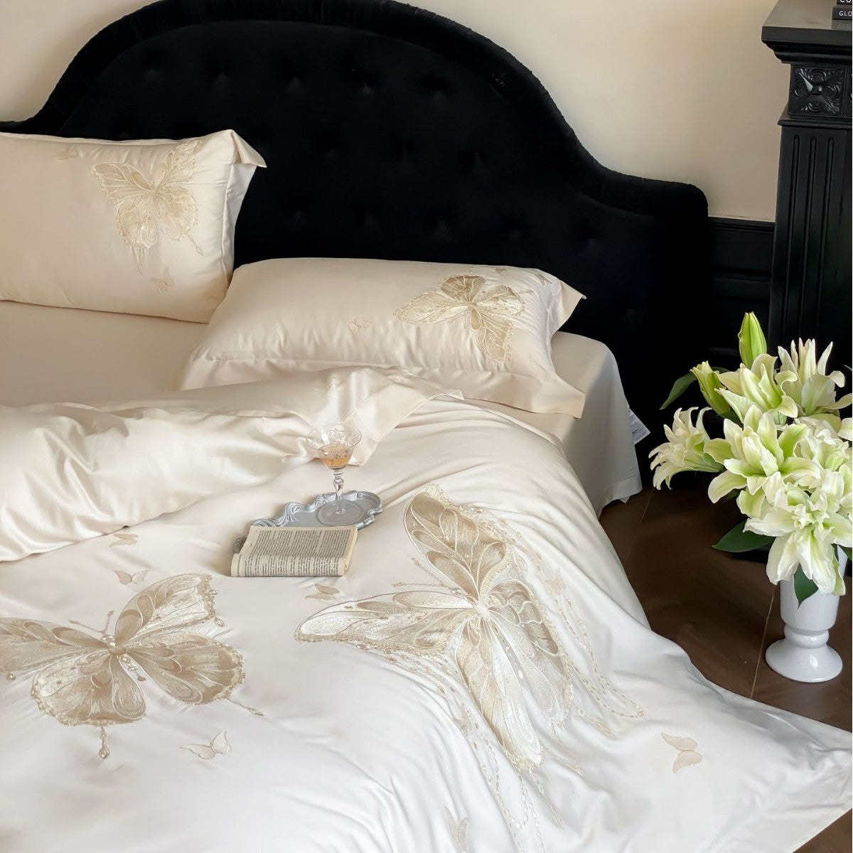 Luxurious satin bedding set with embroidered butterfly motifs and silky glossy finish